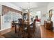 Spacious dining room with a chandelier, hardwood floors, and elegant furniture at 1044 Martin Ln., Conway, SC 29526