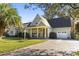 Beautiful exterior with a welcoming porch, well-manicured lawn, and attached two-car garage at 1044 Martin Ln., Conway, SC 29526