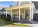 Charming front porch with classic rocking chairs, decorative columns, and a welcoming entrance at 1044 Martin Ln., Conway, SC 29526