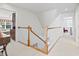 Bright hallway leading to other rooms featuring white carpet and a wooden banister at 1044 Martin Ln., Conway, SC 29526