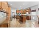 Spacious kitchen with tile floors, wood cabinets, granite countertops, and kitchen island at 1044 Martin Ln., Conway, SC 29526