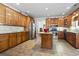Open kitchen area featuring stainless steel appliances, kitchen island, tile floors and wood cabinets at 1044 Martin Ln., Conway, SC 29526