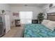 Comfortable bedroom featuring wood-style floors, stylish decor, and good natural lighting at 108 Pipers Ln. # 108, Myrtle Beach, SC 29575