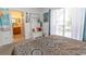 Inviting bedroom featuring a comfortable bed, natural light from the window, and a view to a charming bathroom at 108 Pipers Ln. # 108, Myrtle Beach, SC 29575