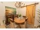 Charming dining area with round table, decorative chandelier, and accent furniture at 108 Pipers Ln. # 108, Myrtle Beach, SC 29575
