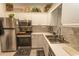 Well-equipped kitchen featuring stainless steel appliances and bright white cabinetry at 108 Pipers Ln. # 108, Myrtle Beach, SC 29575