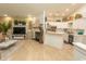 Open living area with a fireplace, TV, decor, and an adjacent kitchen with white cabinets at 108 Pipers Ln. # 108, Myrtle Beach, SC 29575