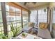 Enclosed sunroom featuring daybeds, turtle statue and views of the lush landscape at 108 Pipers Ln. # 108, Myrtle Beach, SC 29575
