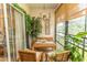 Relaxing sunroom space featuring dining set, chandelier and plants at 108 Pipers Ln. # 108, Myrtle Beach, SC 29575