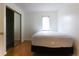A cozy bedroom offers a bed, wood floors, a closet with mirrored doors, and a window at 1100 Possum Trot Dr. # D106, North Myrtle Beach, SC 29582