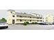 Charming condominium exterior with yellow siding, multiple balconies, and ample parking at 1100 Possum Trot Dr. # D106, North Myrtle Beach, SC 29582
