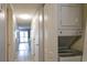 View of a hallway featuring tile floors, a laundry nook, and a view into the living room with a sliding glass door at 1100 Possum Trot Dr. # D106, North Myrtle Beach, SC 29582