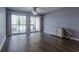 Living room with sliding glass doors to balcony, hard surface floors, ceiling fan, and starfish decor at 1100 Possum Trot Dr. # D106, North Myrtle Beach, SC 29582