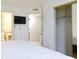 A bright main bedroom featuring an en suite bathroom, closet and a bed with a white patterned comforter at 1100 Possum Trot Dr. # D106, North Myrtle Beach, SC 29582
