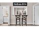 Charming bar area featuring seating, granite countertop and views into the kitchen area at 110-1 Whitetail Way # 1, Pawleys Island, SC 29585