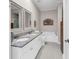 White bathroom with granite counter tops, dual sinks, and soaking tub at 110-1 Whitetail Way # 1, Pawleys Island, SC 29585