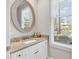 A lovely bathroom featuring a granite countertop, a round mirror and lots of natural light at 110-1 Whitetail Way # 1, Pawleys Island, SC 29585