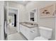 Bathroom features dual sinks, granite counters, and access to Primary bedroom at 110-1 Whitetail Way # 1, Pawleys Island, SC 29585