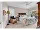 Bright bedroom featuring an upholstered chair, floral bedding, and sliding glass doors to outdoor patio at 110-1 Whitetail Way # 1, Pawleys Island, SC 29585