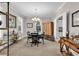Bright dining room featuring chandelier lighting, wooden furniture, and a window at 110-1 Whitetail Way # 1, Pawleys Island, SC 29585