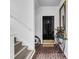 A welcoming entryway featuring brick floors, a black door, a mirror, and stair access at 110-1 Whitetail Way # 1, Pawleys Island, SC 29585