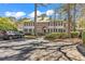 Elegant two-story home featuring a lush green yard and a private driveway with ample parking at 110-1 Whitetail Way # 1, Pawleys Island, SC 29585