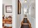 Long hallway with wood floors, white doors, and decorative accents at 110-1 Whitetail Way # 1, Pawleys Island, SC 29585