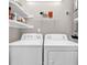 Functional laundry room with washer, dryer, and ample shelving for storage at 110-1 Whitetail Way # 1, Pawleys Island, SC 29585