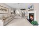 Bright and cozy living room featuring a fireplace, neutral decor, comfortable seating, and a bar area at 110-1 Whitetail Way # 1, Pawleys Island, SC 29585