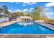 Community pool with clear blue water, spacious deck, and adjacent recreation building at 110-1 Whitetail Way # 1, Pawleys Island, SC 29585
