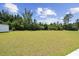 Green backyard with mature trees and concrete patio space at 1102 Boswell Ct., Conway, SC 29526