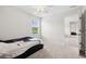 Neutral bedroom features a bed, plush carpet, ceiling fan, and sunny window at 1102 Boswell Ct., Conway, SC 29526