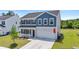 Charming two-story home featuring a well-manicured lawn and a two-car garage at 1102 Boswell Ct., Conway, SC 29526