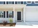 Inviting covered front porch with classic columns and black front door at 1102 Boswell Ct., Conway, SC 29526