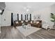 Spacious living room features a plush sofa, neutral rug, and large windows at 1102 Boswell Ct., Conway, SC 29526