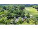 An aerial view shows a golf course and clubhouse surrounded by lush greenery and mature trees at 1221 Tidewater Dr. # 122, North Myrtle Beach, SC 29582