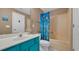 Bathroom with a turquoise vanity and a shower with a colorful ocean themed curtain at 1221 Tidewater Dr. # 122, North Myrtle Beach, SC 29582