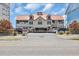 Inviting coastal home featuring a red roof, ample parking, and a covered entrance, perfect for beach living at 1221 Tidewater Dr. # 122, North Myrtle Beach, SC 29582