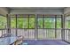 Sunroom with a round table and chairs, screened windows, and view of wooded exterior at 1221 Tidewater Dr. # 122, North Myrtle Beach, SC 29582
