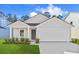 Inviting single-level home featuring a gray exterior, tidy landscaping, and an attached two-car garage at 1230 Willow Oaks Way, Conway, SC 29526
