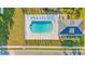 Aerial view of a pool and a pool house surrounded by lounge chairs and grass at 1352 Jolly Roger Dr., North Myrtle Beach, SC 29582