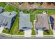 Aerial view of homes with manicured lawns, palm trees, fences, driveways, and neighborhood street at 1352 Jolly Roger Dr., North Myrtle Beach, SC 29582