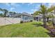 Well-manicured backyard with lush green grass, palm tree, and a screened-in porch at 1352 Jolly Roger Dr., North Myrtle Beach, SC 29582