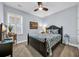 This bedroom features a ceiling fan and a dark wood bed frame with a tropical patterned bedspread at 1352 Jolly Roger Dr., North Myrtle Beach, SC 29582