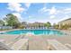 Community pool and lounge chairs surrounded by mature trees and well-maintained residential buildings at 1352 Jolly Roger Dr., North Myrtle Beach, SC 29582