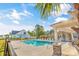 Community pool with lounge chairs, lush landscaping, a pool house, and an attractive residential setting at 1352 Jolly Roger Dr., North Myrtle Beach, SC 29582