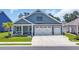 Charming single Gathering home featuring a two car garage, inviting front porch and manicured lawn at 1352 Jolly Roger Dr., North Myrtle Beach, SC 29582