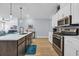 This is a modern kitchen with stainless steel appliances, white cabinets, and dark blue backsplash at 1352 Jolly Roger Dr., North Myrtle Beach, SC 29582