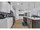 This is a modern kitchen with white cabinets, stainless steel appliances, and an island at 1352 Jolly Roger Dr., North Myrtle Beach, SC 29582