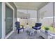 Relaxing screened-in porch with comfortable seating, stone floors, and outdoor views through adjustable privacy shades at 1352 Jolly Roger Dr., North Myrtle Beach, SC 29582